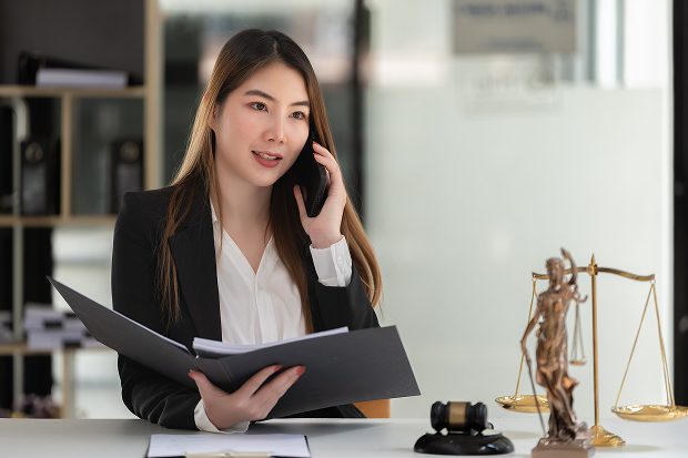female lawyer talking with client over the phone.